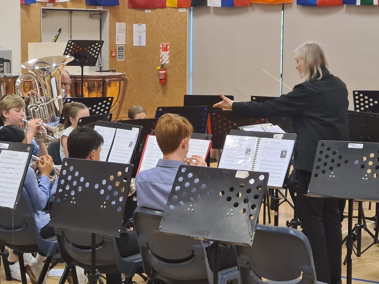 Academy and youth players rehearsing together with their conductor