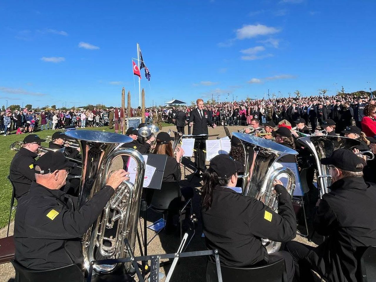 Rolleston Brass performing to a large crowd at a community commemoration